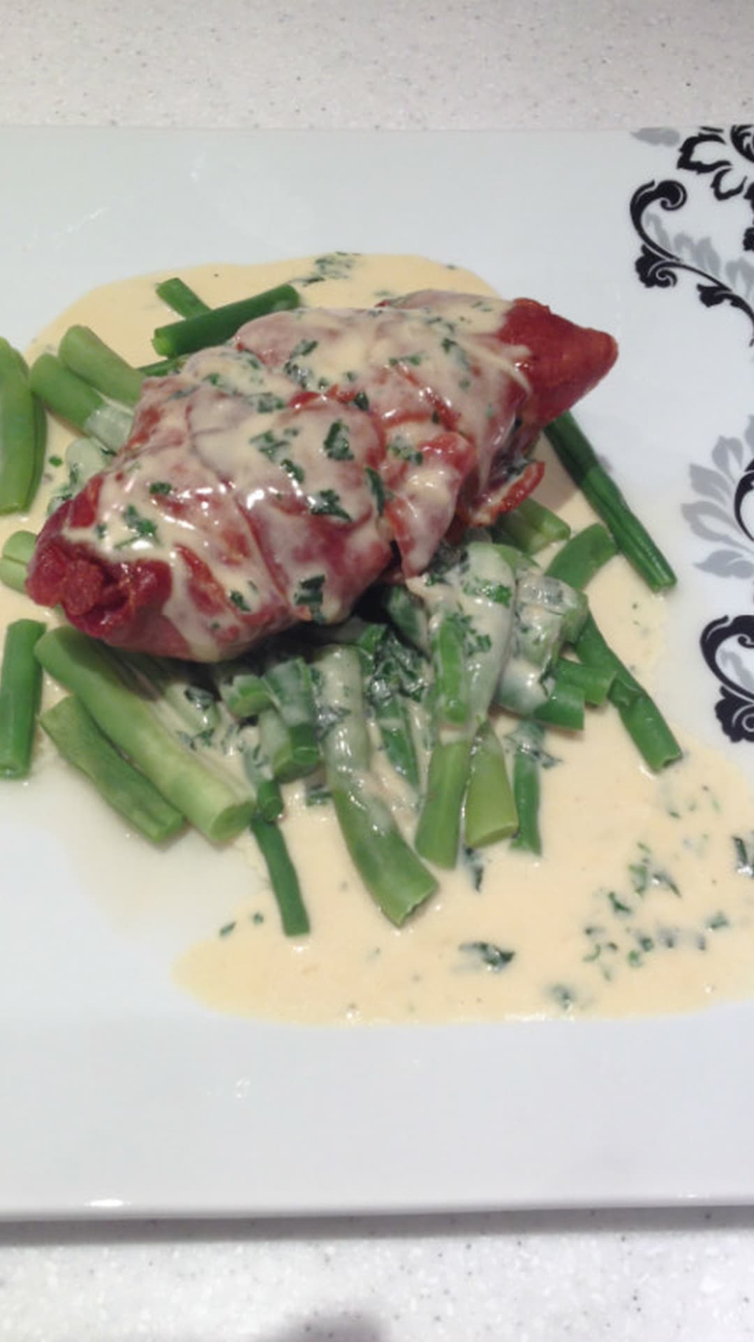 Chicken wrapped in Parma ham with a creamy herb sauce